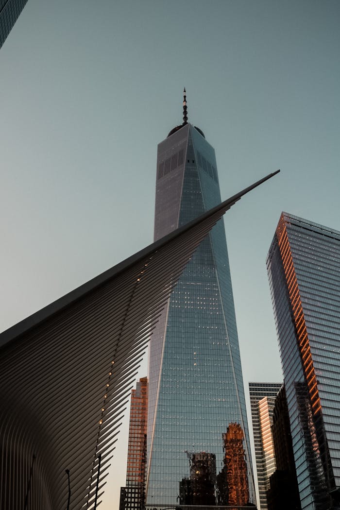 A stunning low angle view of One World Trade Center and the Oculus in New York City at dusk.